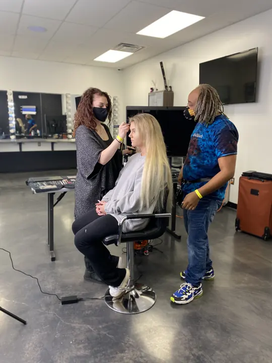 Makeup and hair working side by side