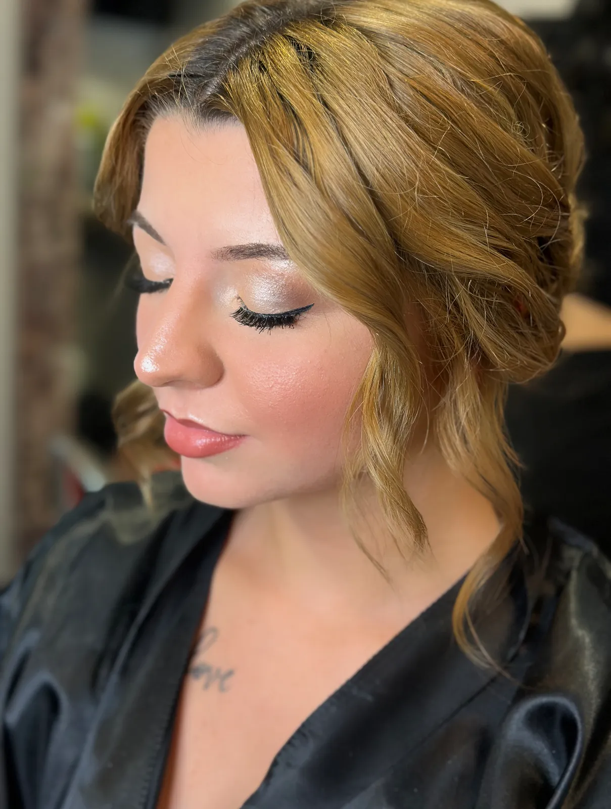Soft glam with a warm shimmer eye and glossy lip, hair in loose golden curls