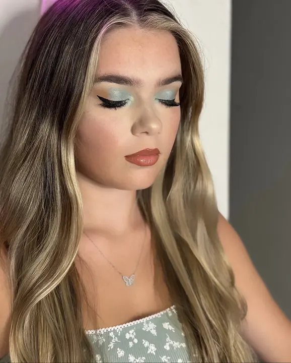 Sage blue eye with a sharp wing and a terracotta lip