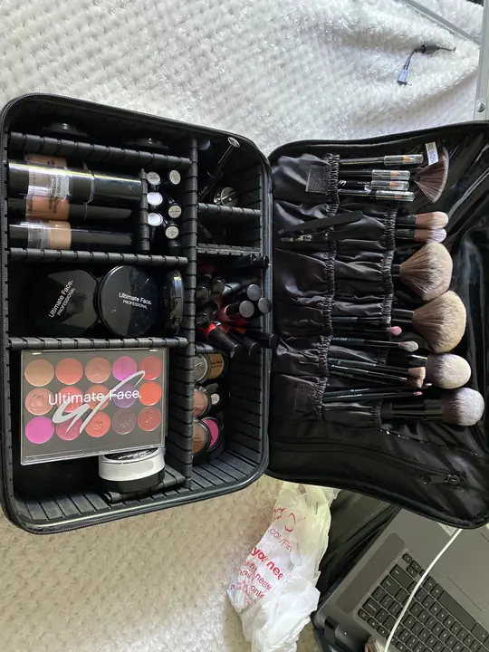 Where it started: a single makeup kit case, open, with foundations, palettes and brushes